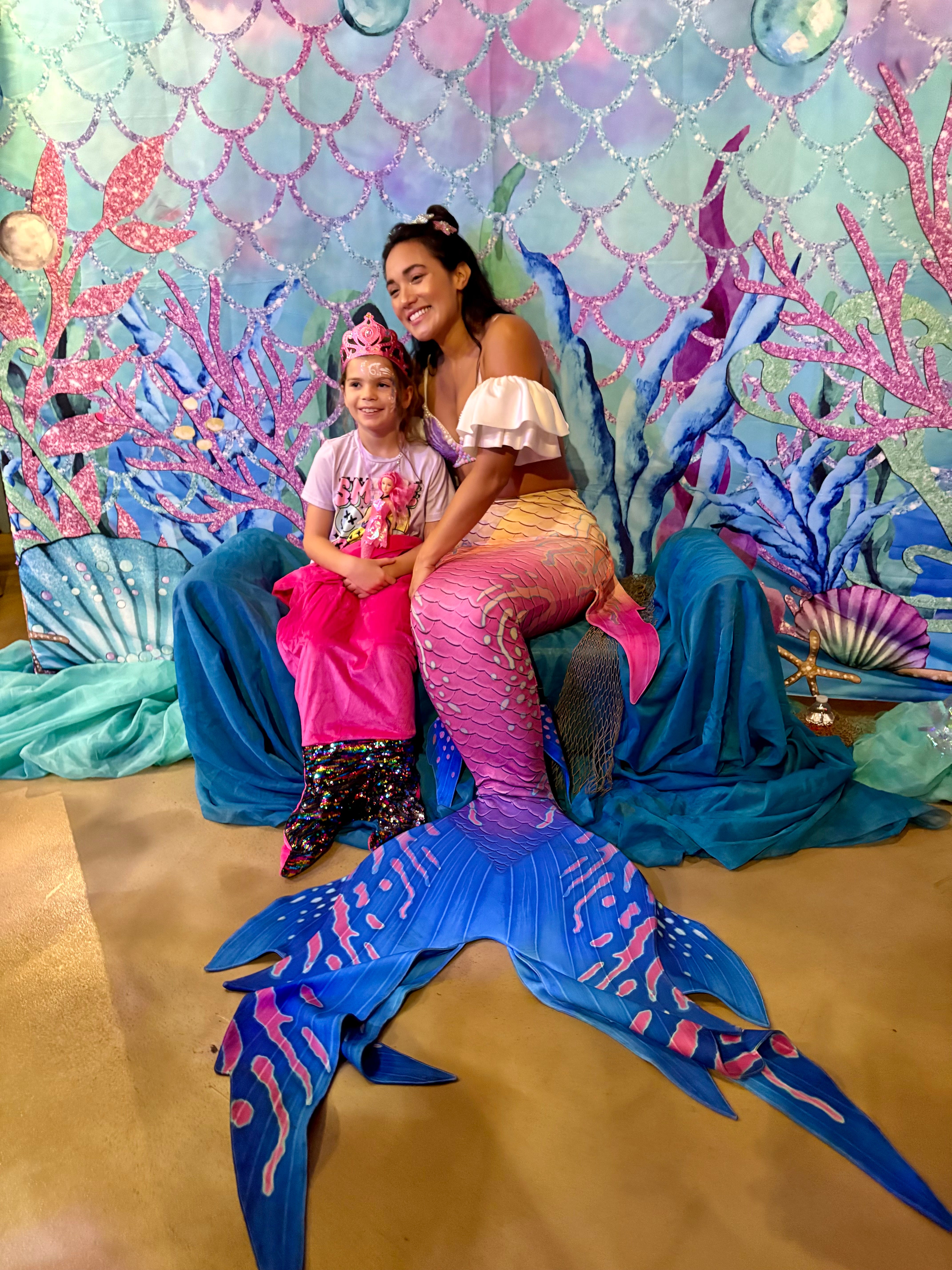 Mermaid meet and greet with young visitor at aquarium