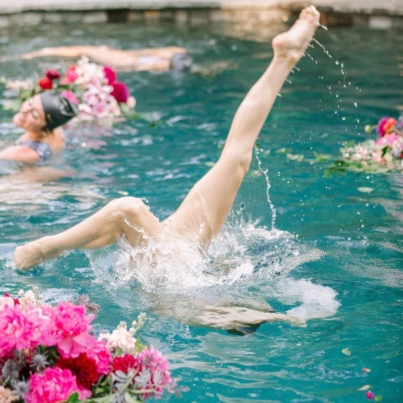Synchronized swimmer performing with flowers